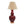 Red table lamp with a beige lampshade on a white background