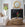 Living room with a white sofa, round wicker coffee table, and decorative items.