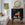 Living room with white sofa, decorative mirror, and black marble fireplace.