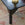 Decorative table leg with floral patterns on a textured rug