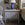 Nighstand with blue lamp and decorative items in a bedroom setting