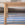 Wooden table with a striped rug in the background