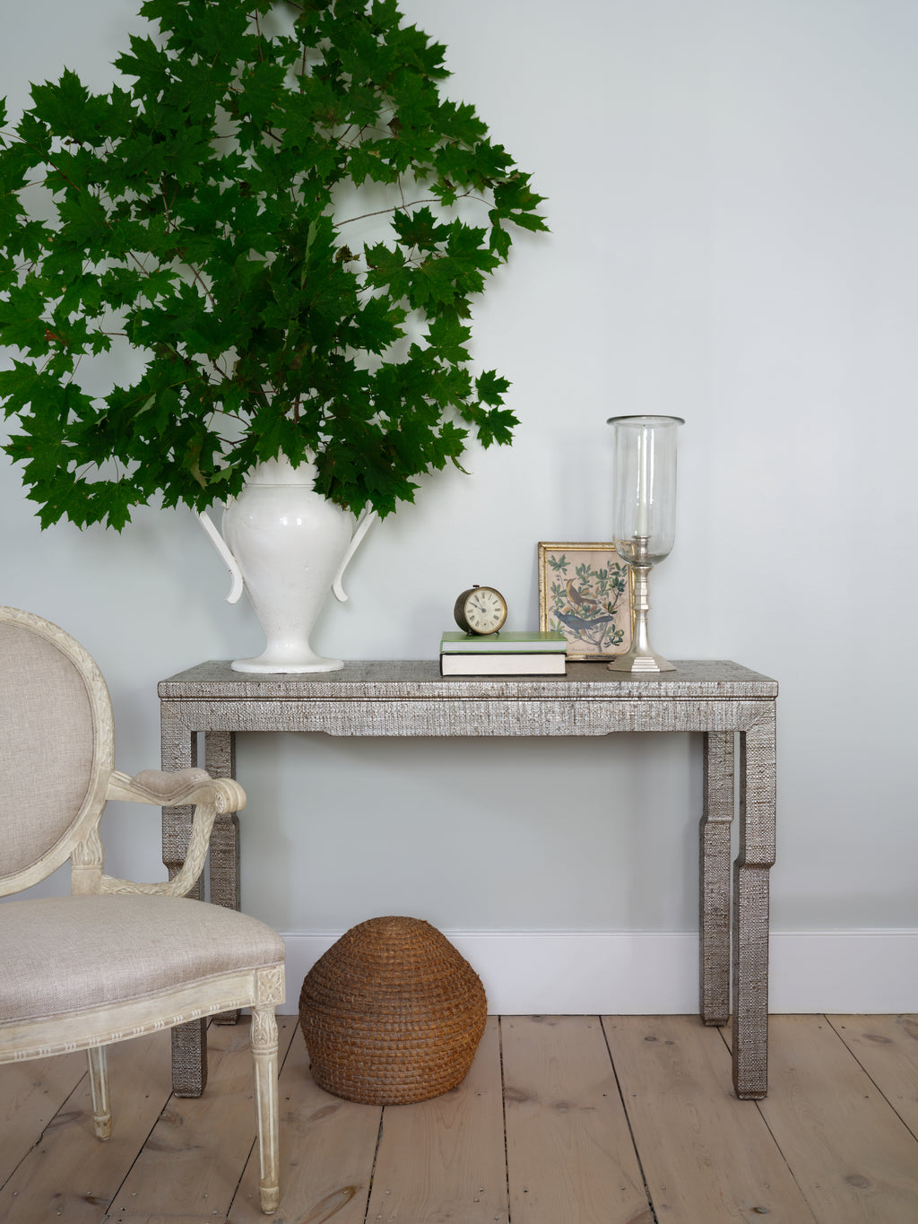 yuri console table featuring a silver grass-woven cloth surface by bunny williams home