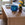Wicker console table with a blue ceramic bowl and potted plant in a home setting