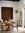 Dining room with wooden table and chairs, floral centerpiece, and decorative wall art.