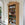 Wooden bookshelf with decorative items against a white wall