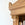 Wooden bookshelf with decorative corner and books on a white background