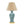 Table lamp with a textured blue base and beige lampshade on a white background