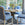 Harvest dining table with hand-carved wood top with wrought iron base by Bunny Williams Home surrounded by blue chairs