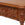Close-up of a wooden sideboard with intricate carvings on a beige background