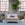 Keller Bed by Bunny Williams Home in a room with large windows and plants