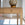 Wooden desk with a decorative lamp on top in a blurred indoor setting