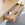Wooden desk with an open drawer containing stationery items.