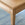Close-up of a wooden desk corner with a blurred blue background