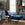 Blue armchair and ottoman with a gold side table in a decorated room.