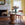 Dining room with a round wicker table, chairs, and decorative items.