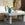 Concrete coffee table with a plant and tray on an outdoor patio