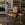Vintage chair with floral pattern in a room with bookshelves and a fireplace.