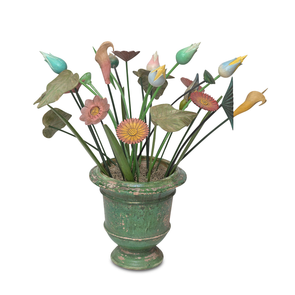 painted wooden flowers in a ceramic urn