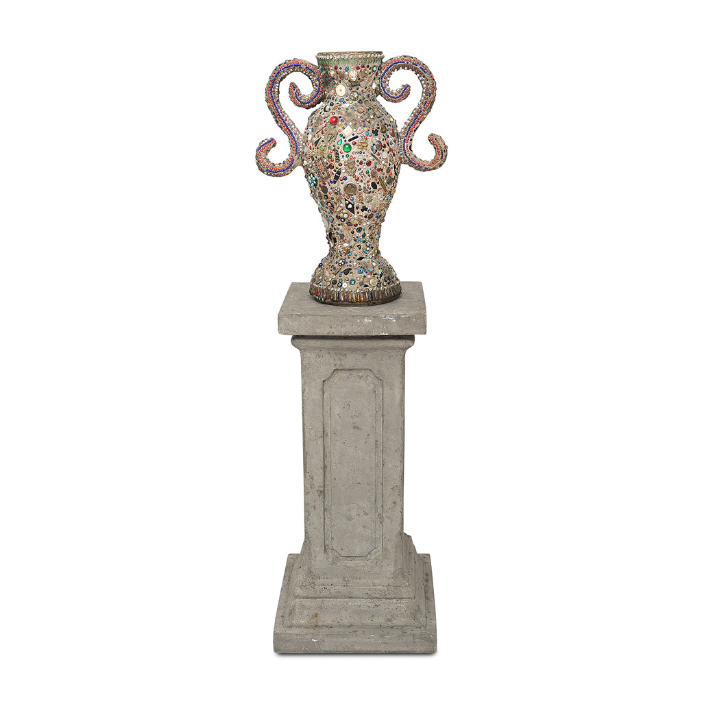 a view of a folk art memory vase with two handles on top of a fiberglass pedestal